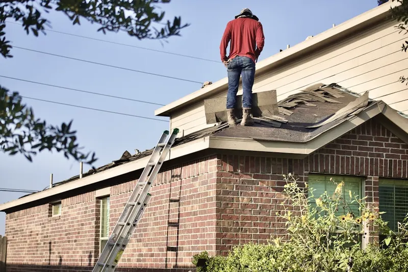 Professional roofer working on a residential roof in West Manayunk